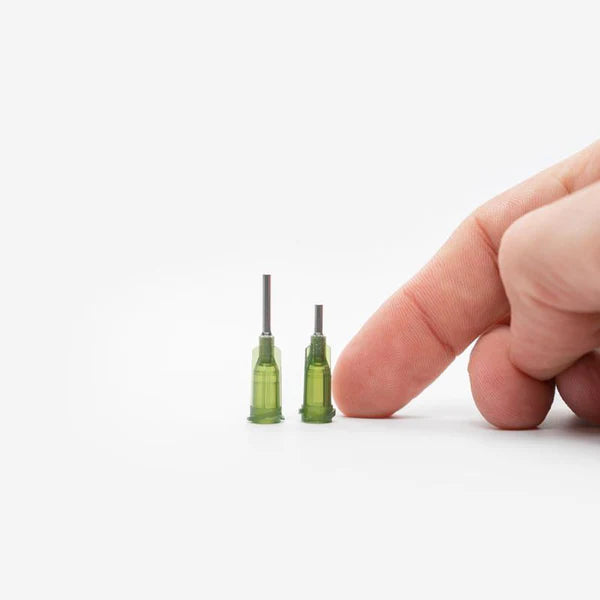 Image showing the size of the oil filling needles compared to a human finger