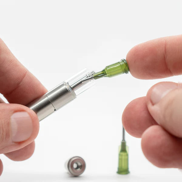 An image showing the size relative to a human hand and demonstrating how to use them to fill a 510 atomizer